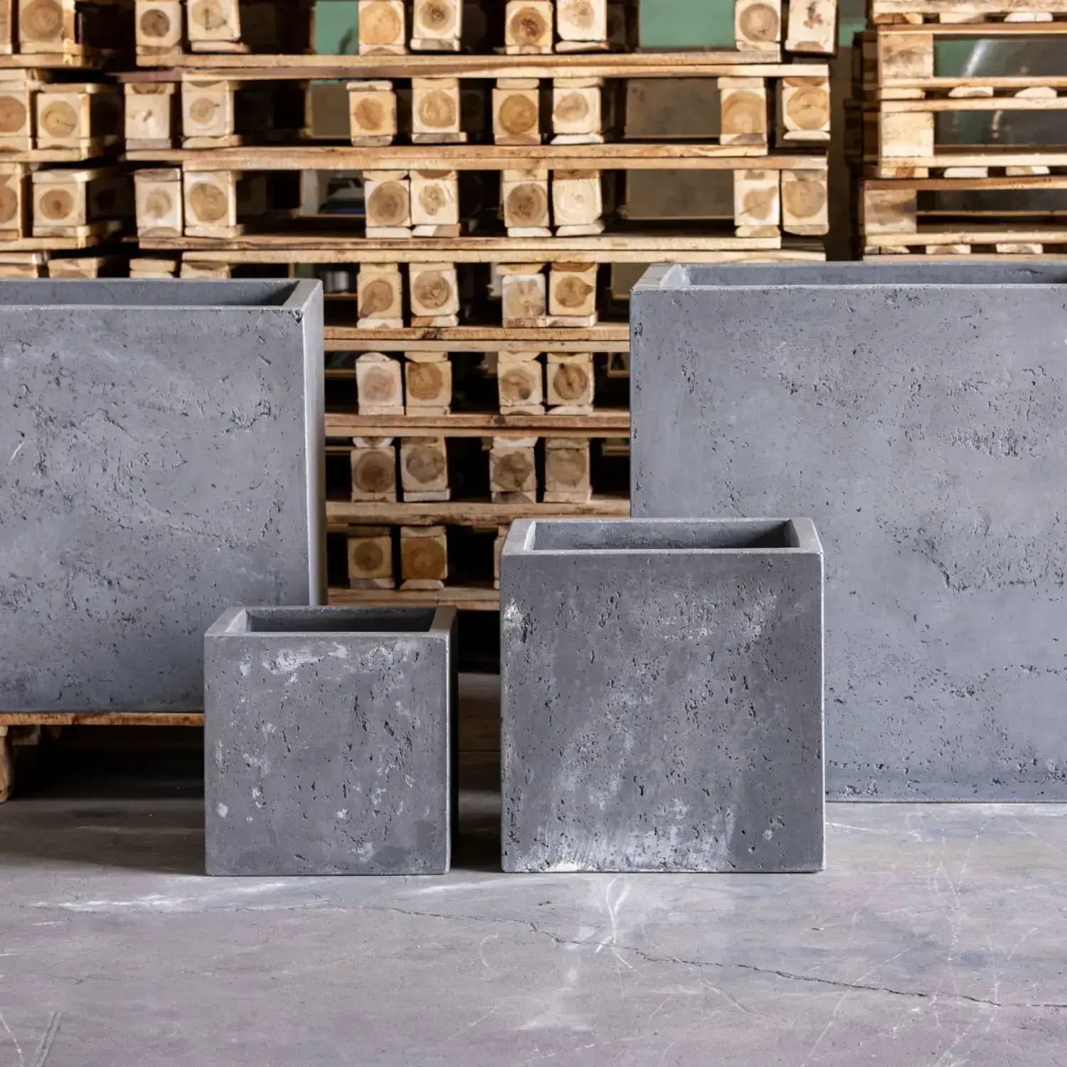 Four gray concrete planters.