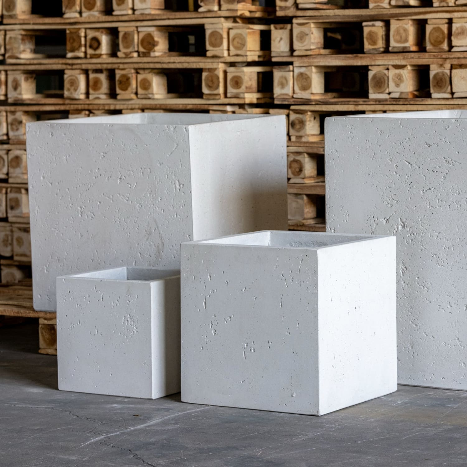 Four white, textured, square planters.