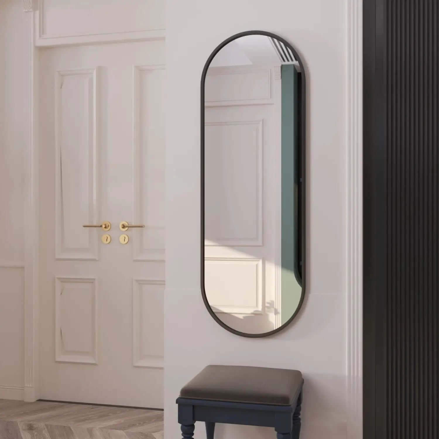 Oval-shaped mirror with a thin black metal frame.