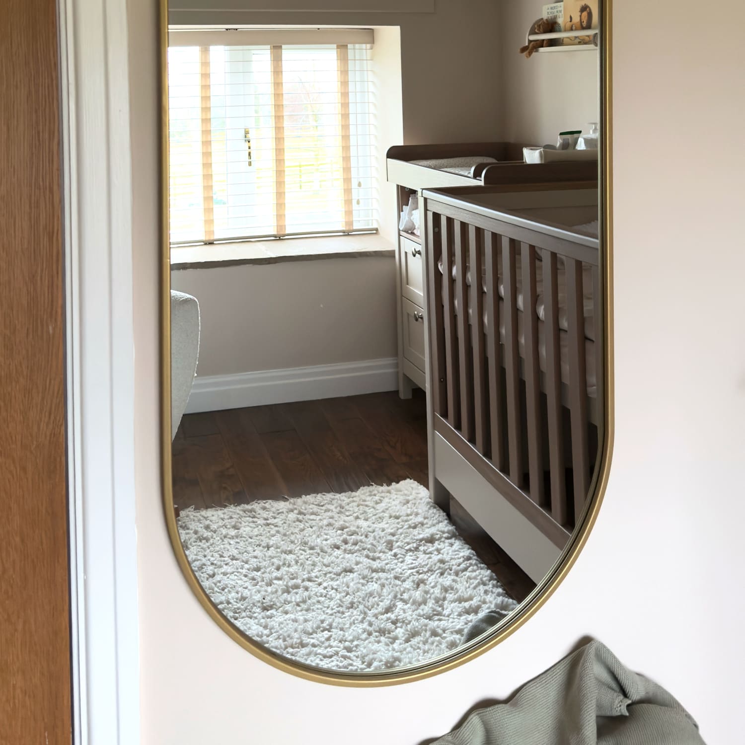 Oval gold-framed mirror.