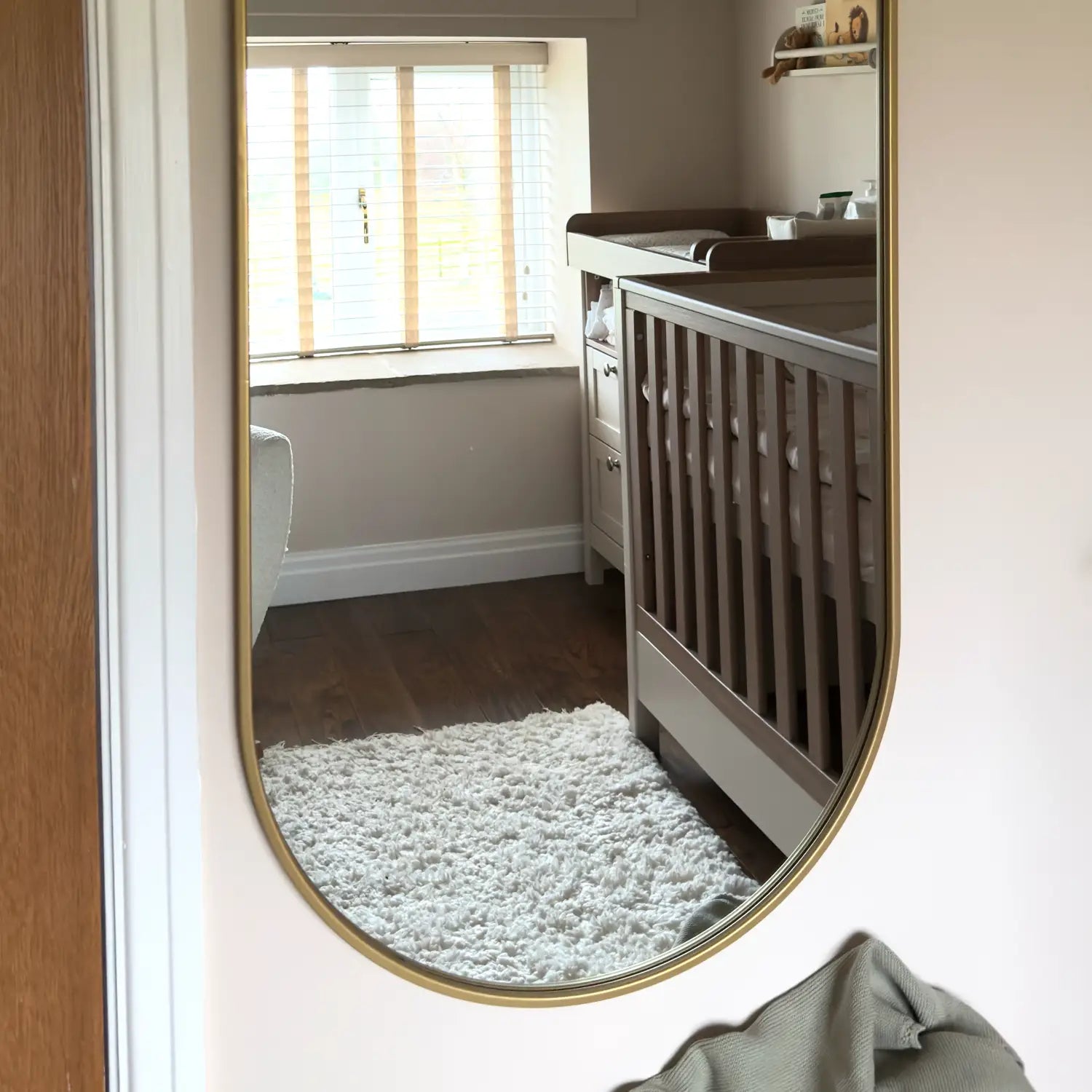 Oval gold-framed mirror.