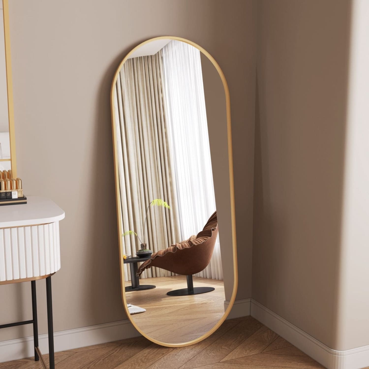 Oval-shaped mirror with a thin gold frame.