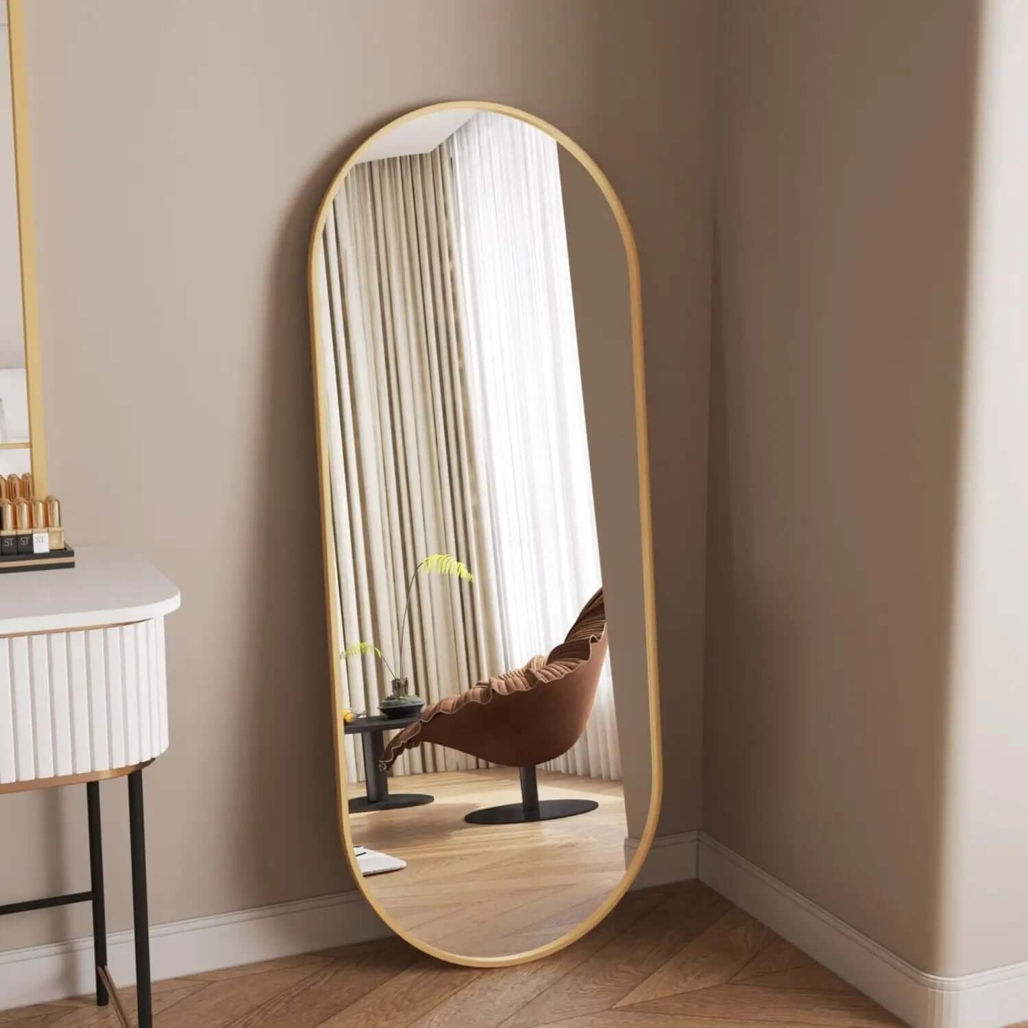 Oval-shaped mirror with a thin gold frame.