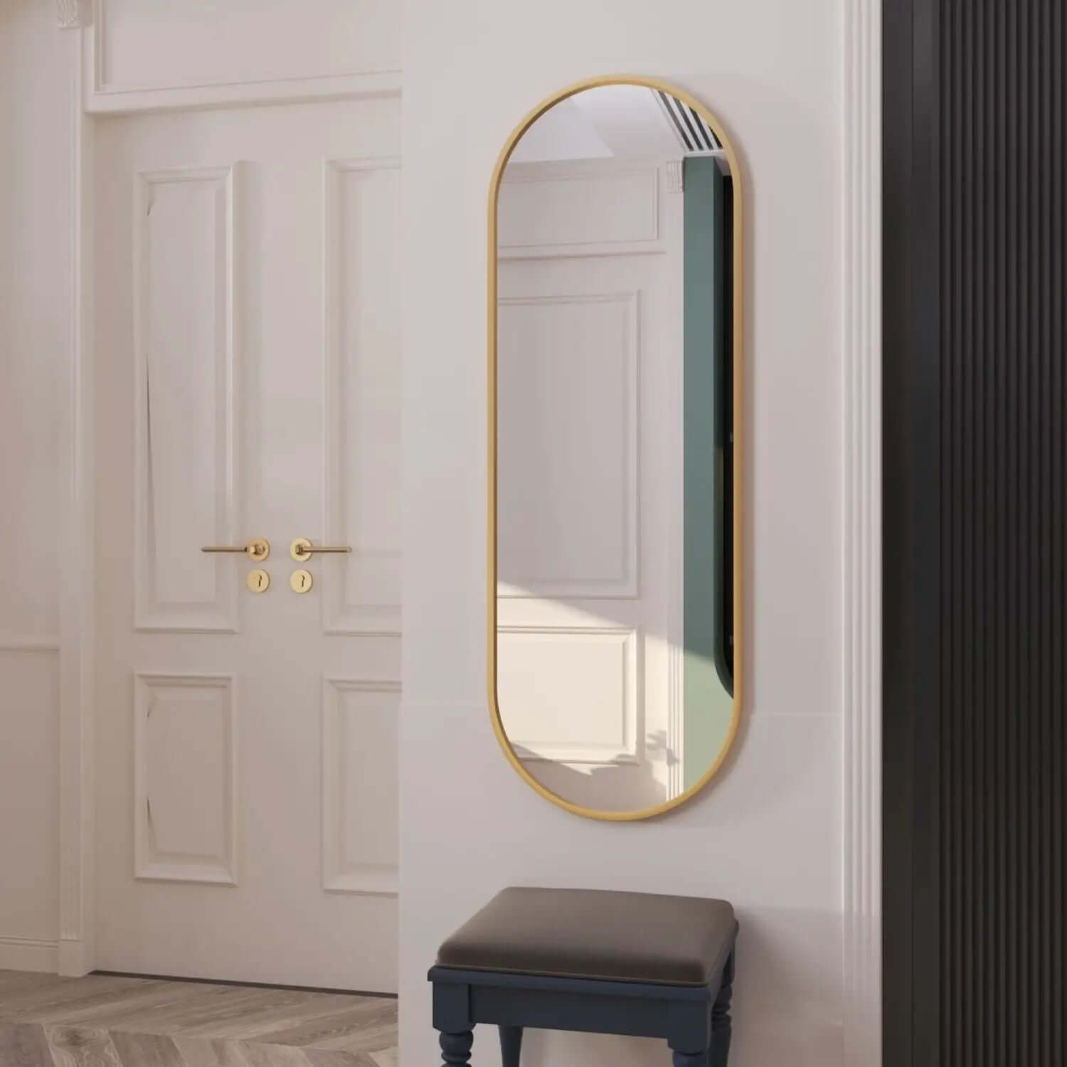 Oval wall mirror with a slim gold-colored metal frame.