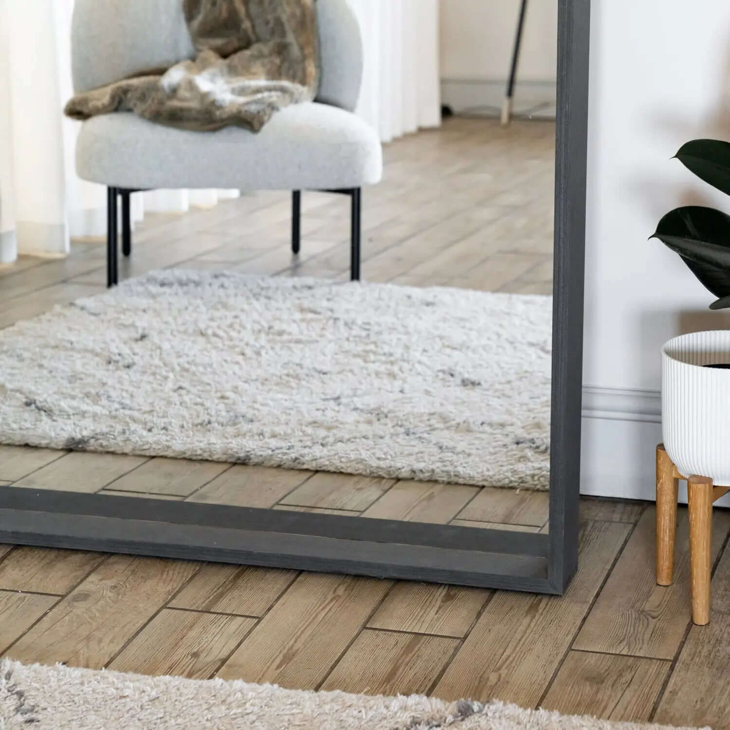 Floor-length mirror with a dark gray metal frame.