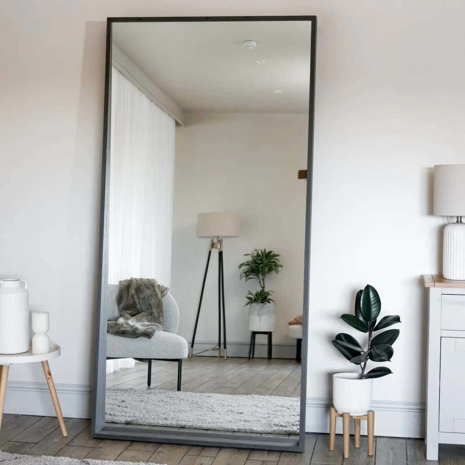 Floor-length mirror with a black metal frame.