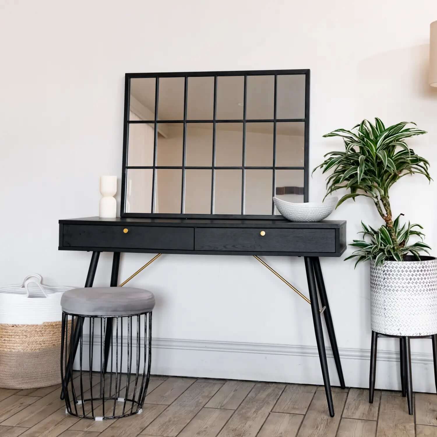 Black console table with two drawers and angled metal legs.