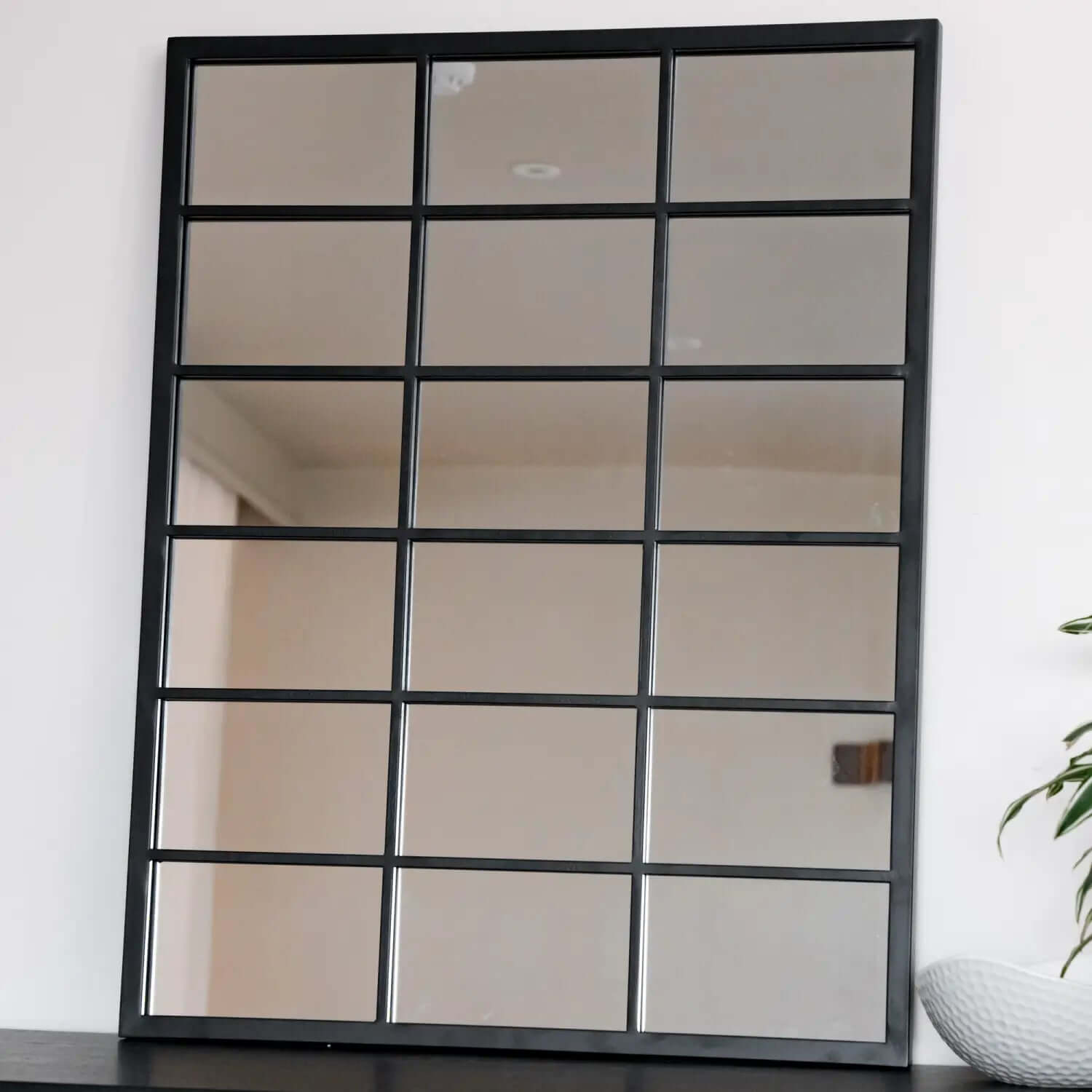 Black-framed window-pane style mirror with 18 rectangular sections.