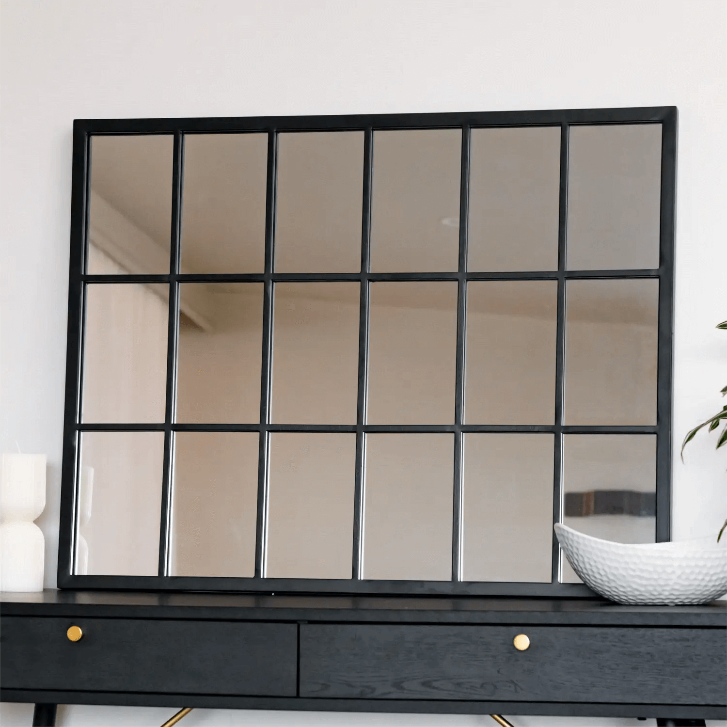 Black-framed windowpane mirror with rectangular grid pattern.