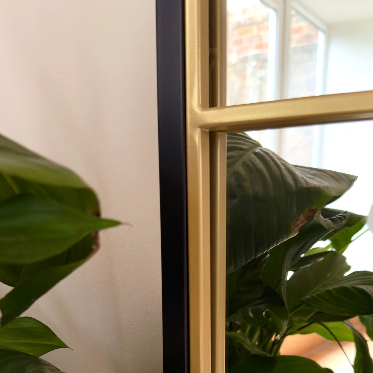 Black and gold framed mirror.