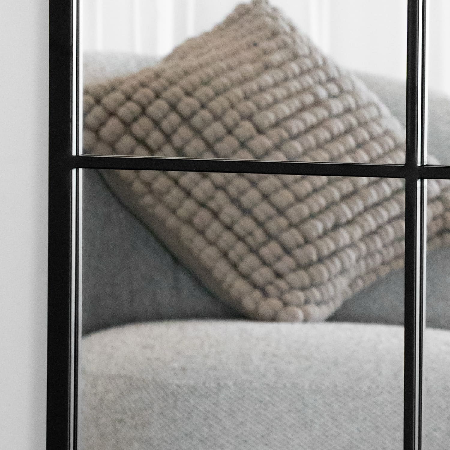 Textured beige throw pillow with a ribbed pattern.