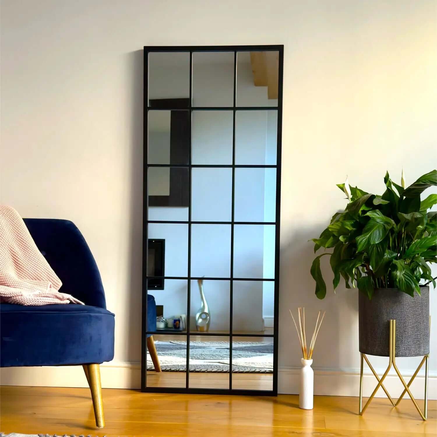 Grid-style mirror with black metal frame divided into rectangular sections.