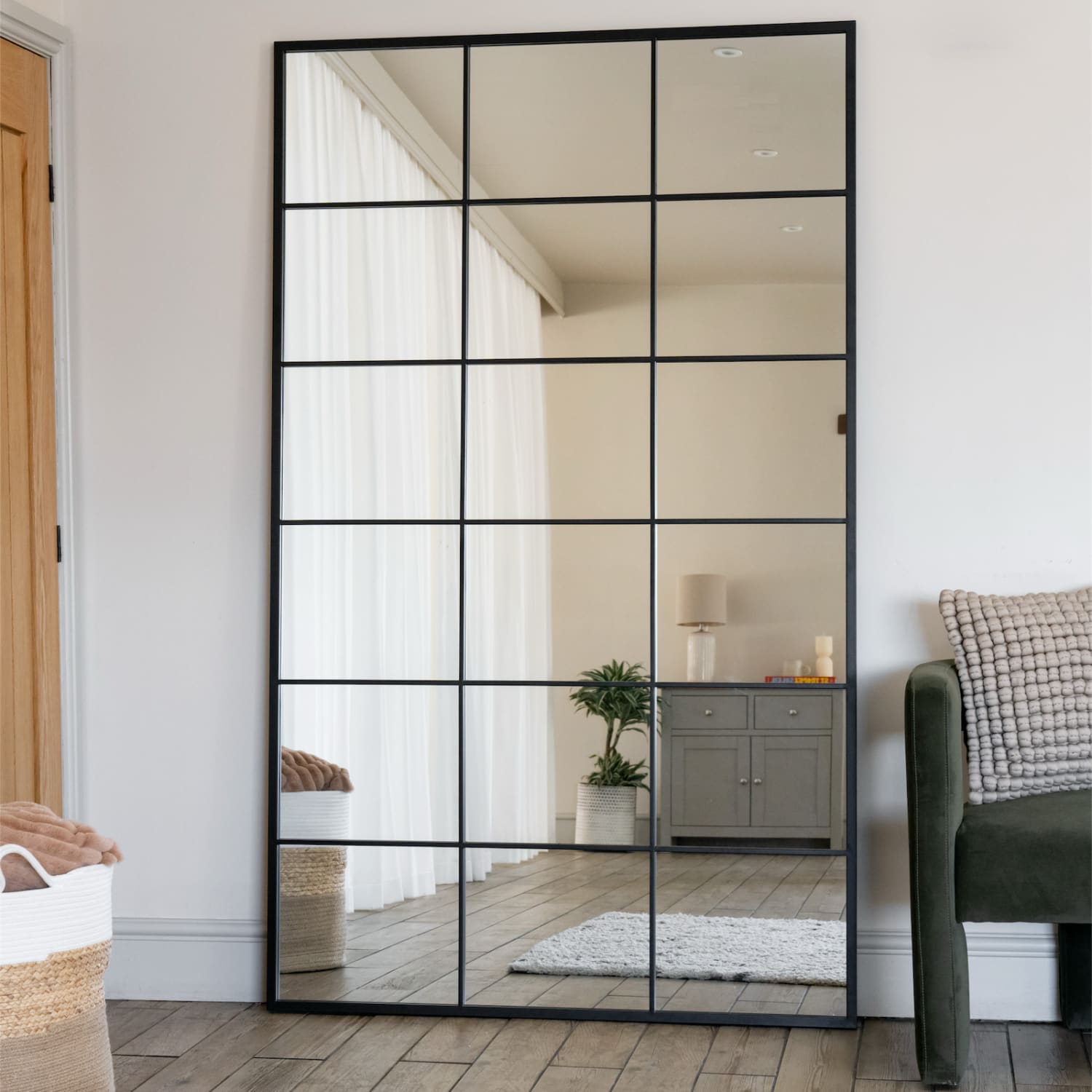 Grid-style mirror with black metal frame divided into rectangular sections.