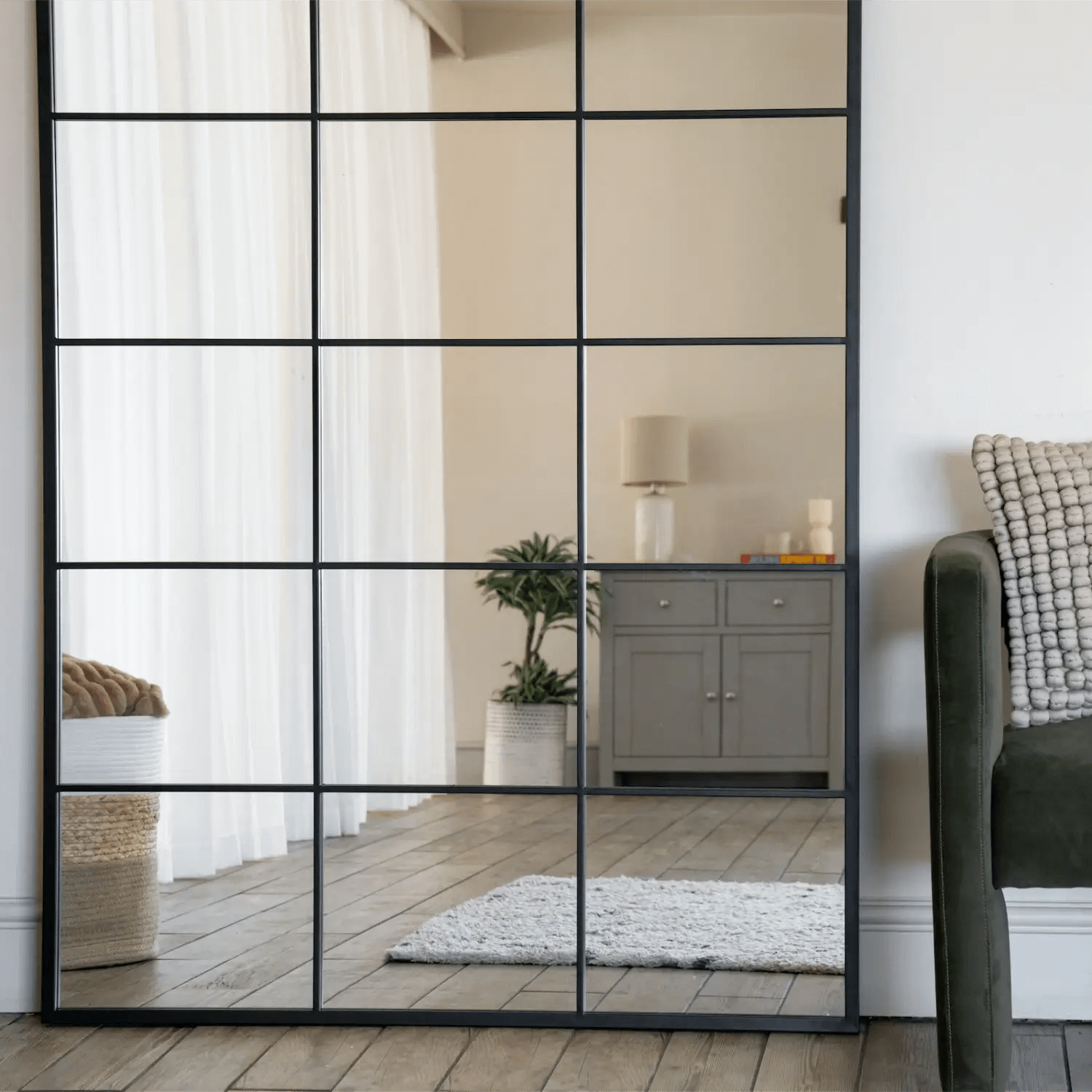 Black-framed glass partition wall with grid pattern.