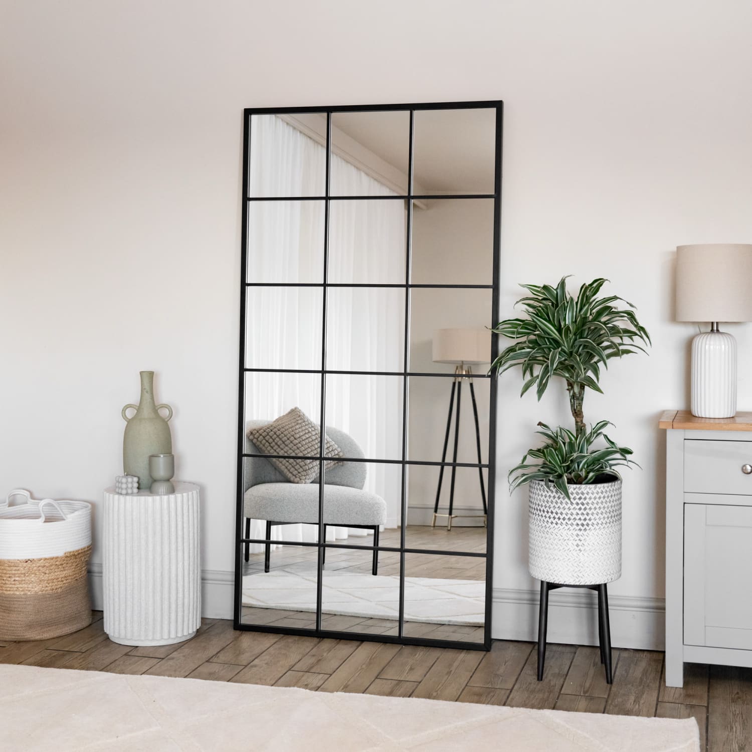 Black-framed rectangular mirror with grid pattern.
