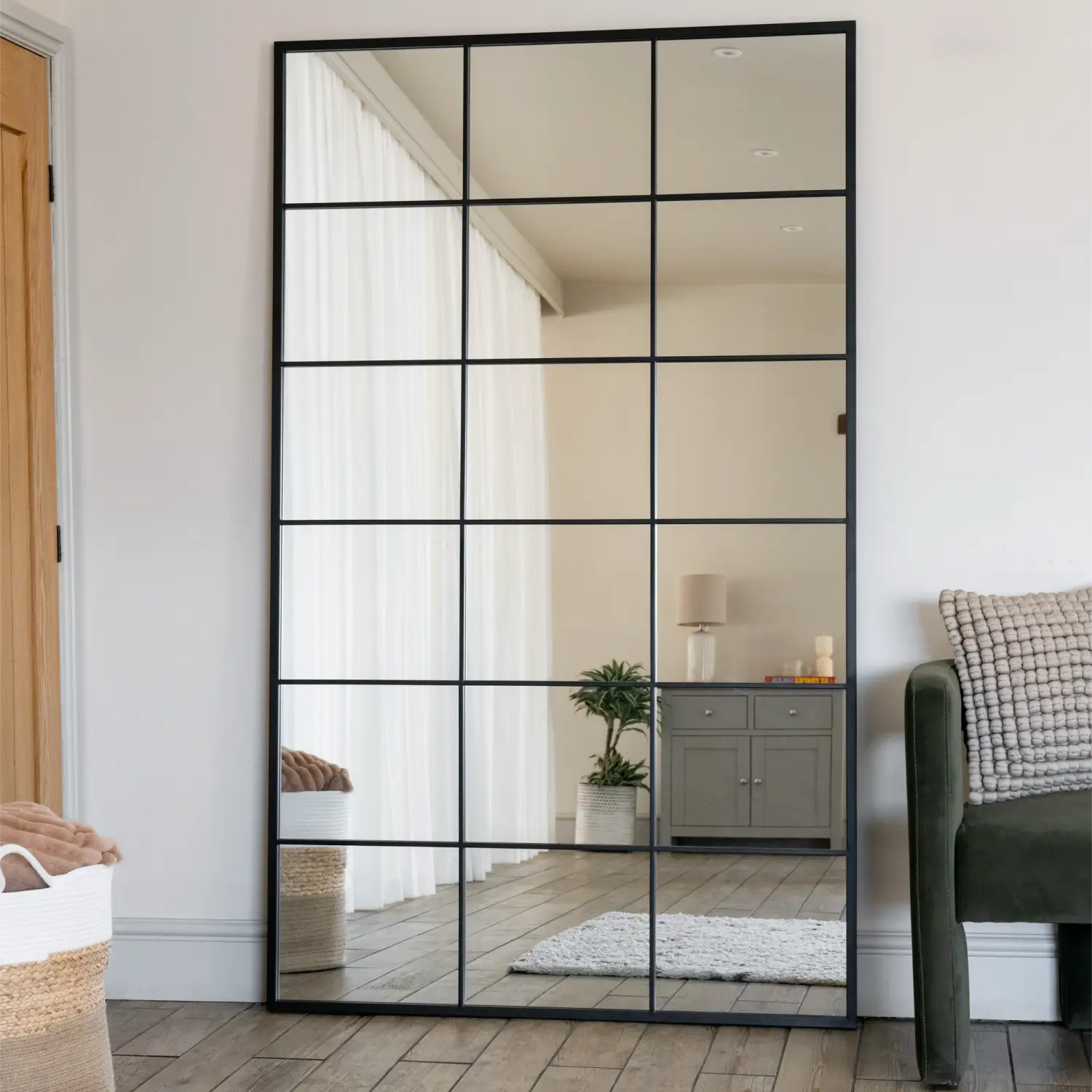 Black-framed windowpane mirror with grid pattern.