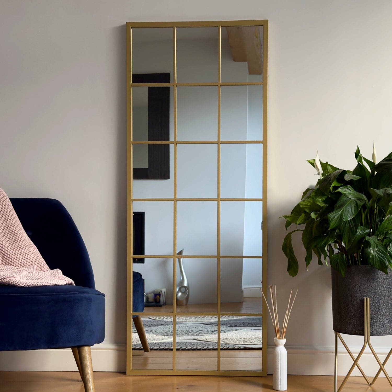 Gold-framed grid mirror.