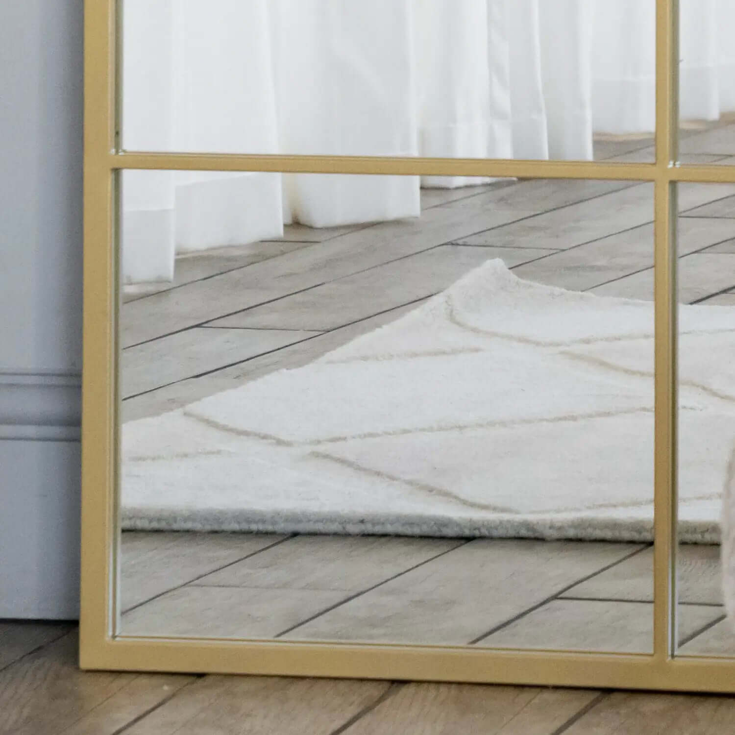 Gold-framed rectangular mirror.