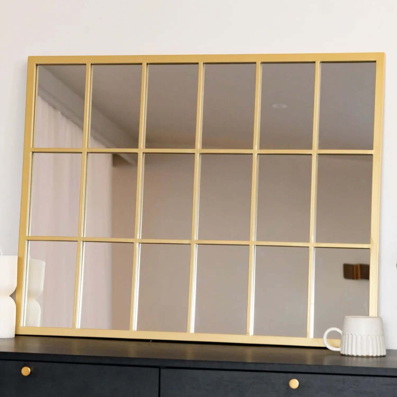 Gold-framed window pane mirror with an 18-panel grid design.