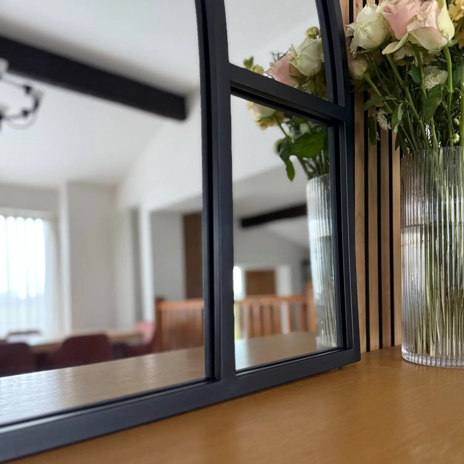 Black-framed mirror with multiple panels.