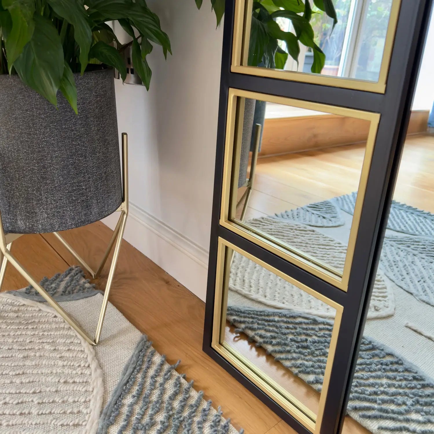 Black and gold framed mirror.