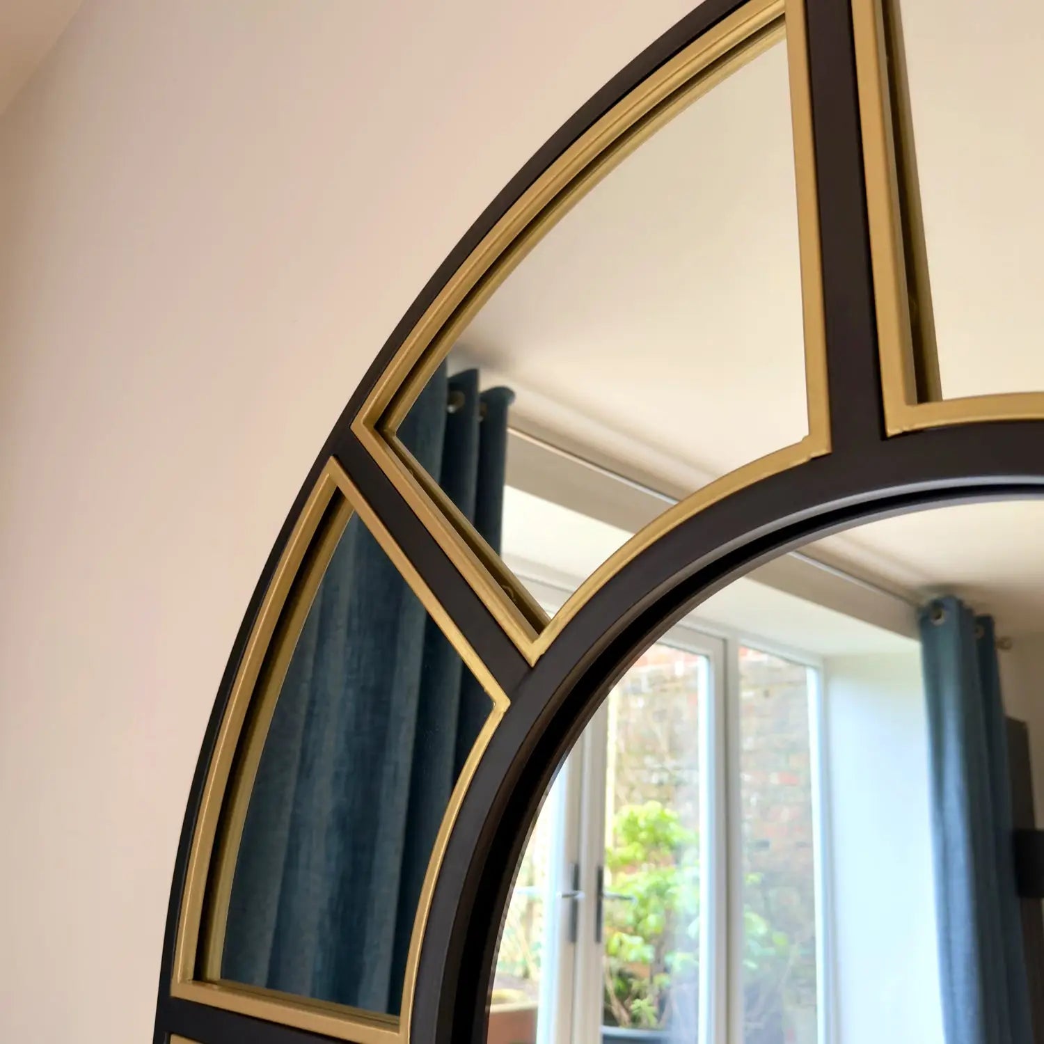 Round black and gold mirror.