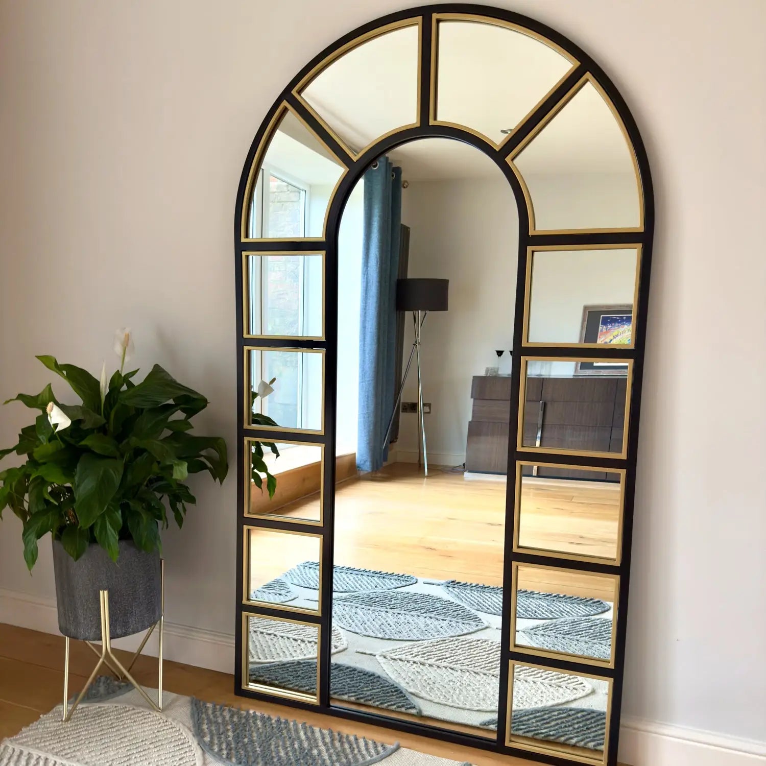 Arched, multi-paneled mirror.