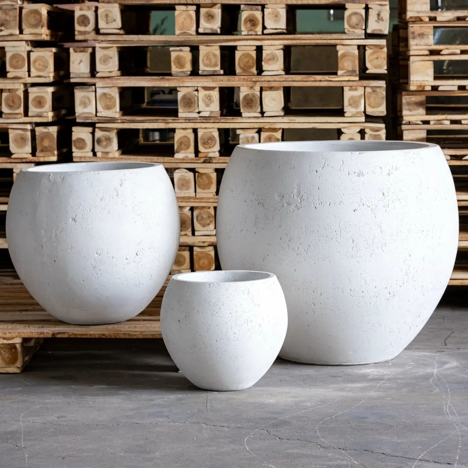 Three round white textured planters.