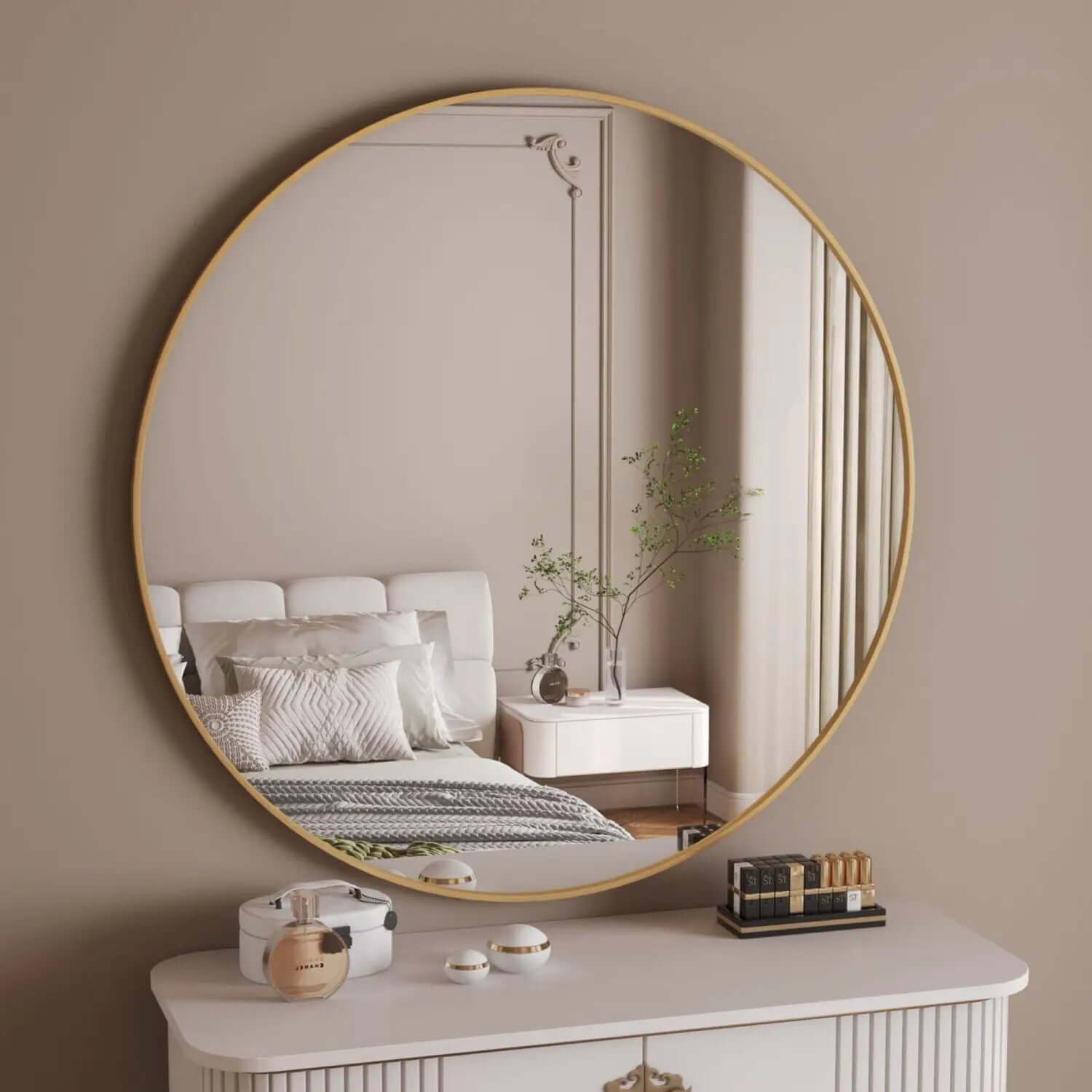 Circular gold-framed mirror mounted on a beige wall.