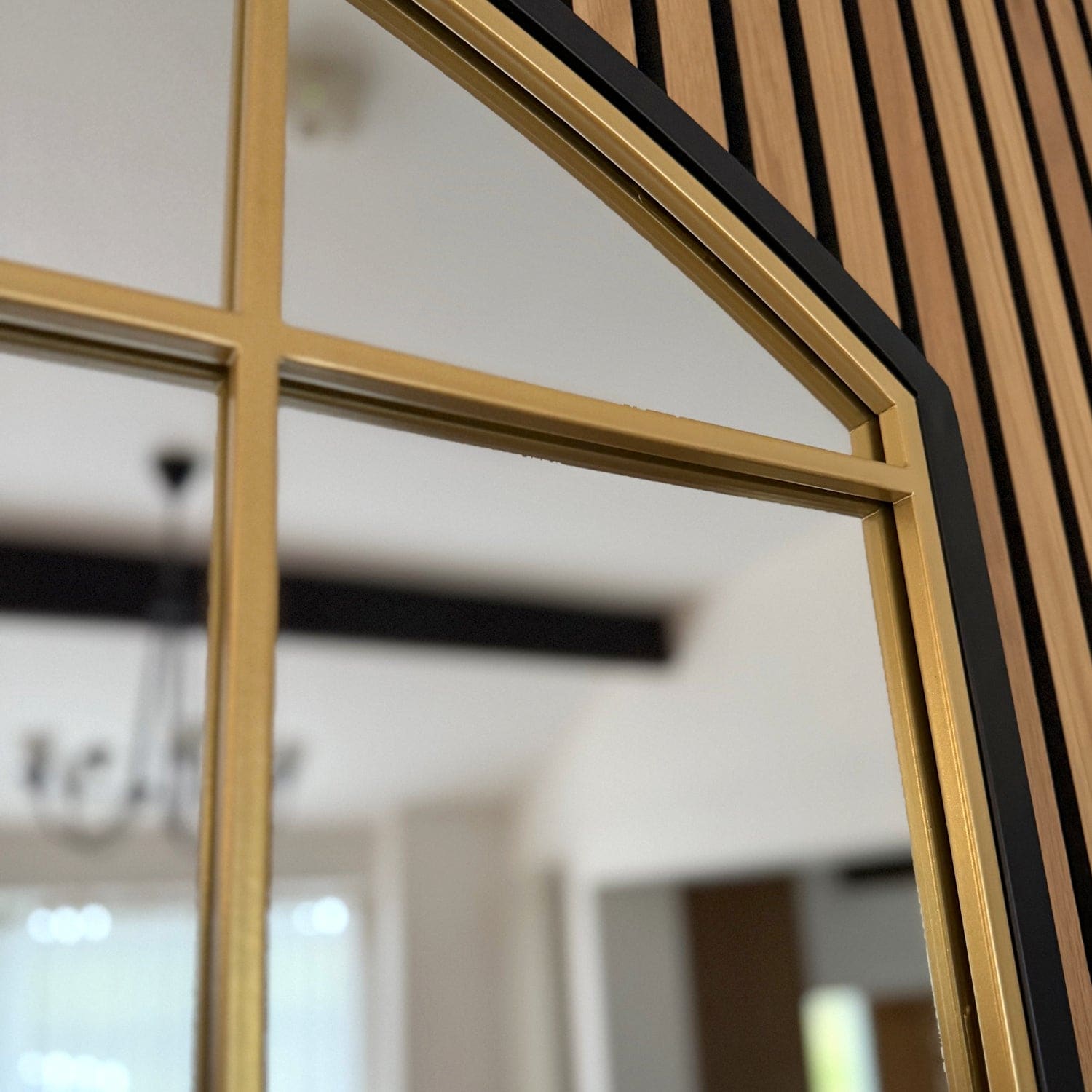 Gold-framed window pane with geometric dividers.