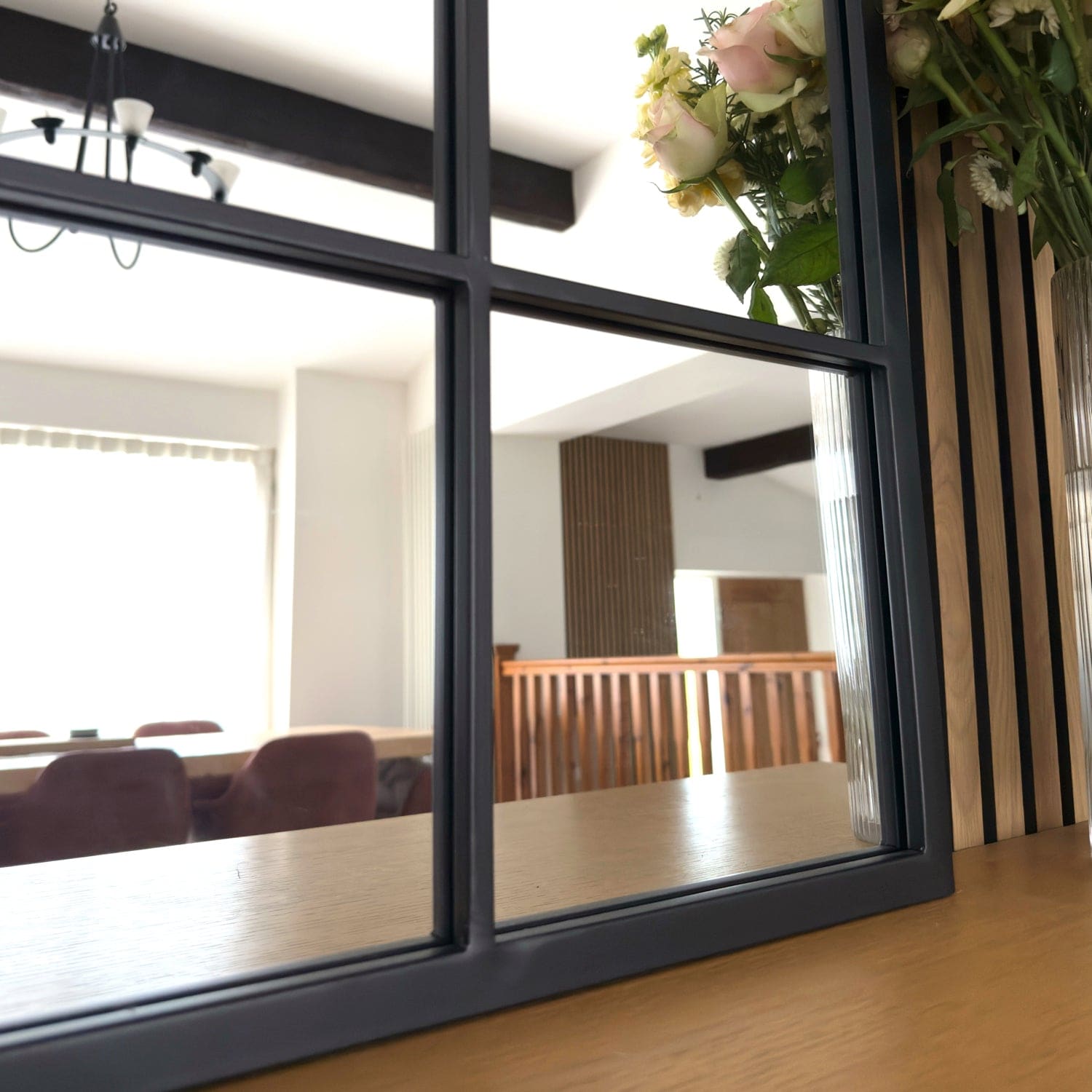 Black-framed window pane dividing interior spaces.