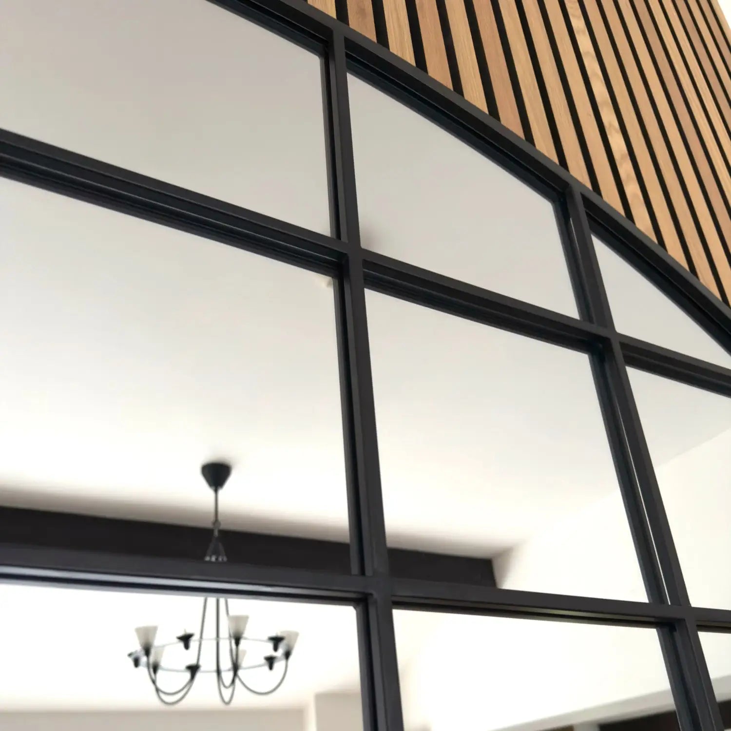 Black-framed window grid with geometric panes.