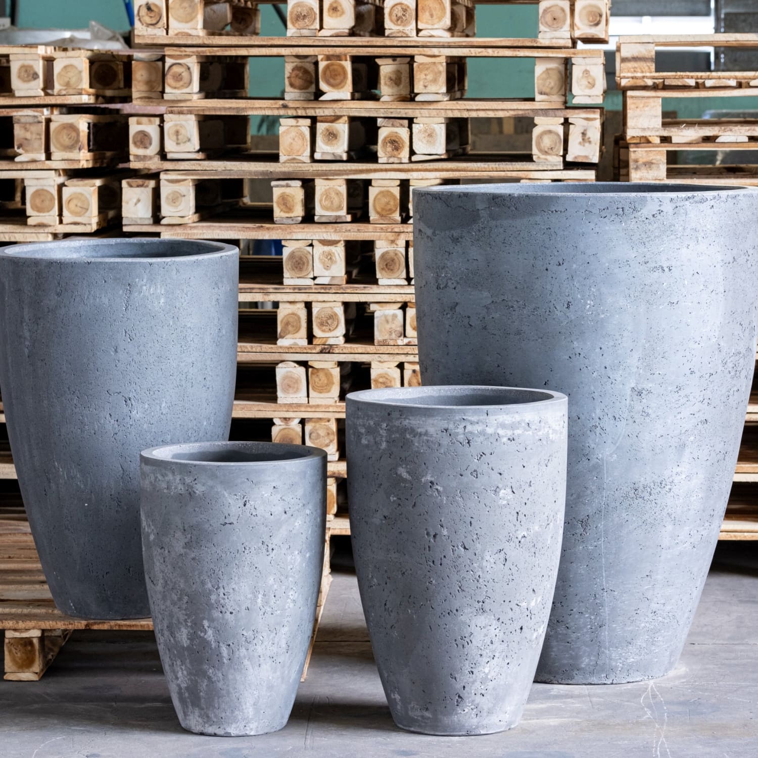 Four gray concrete planters.