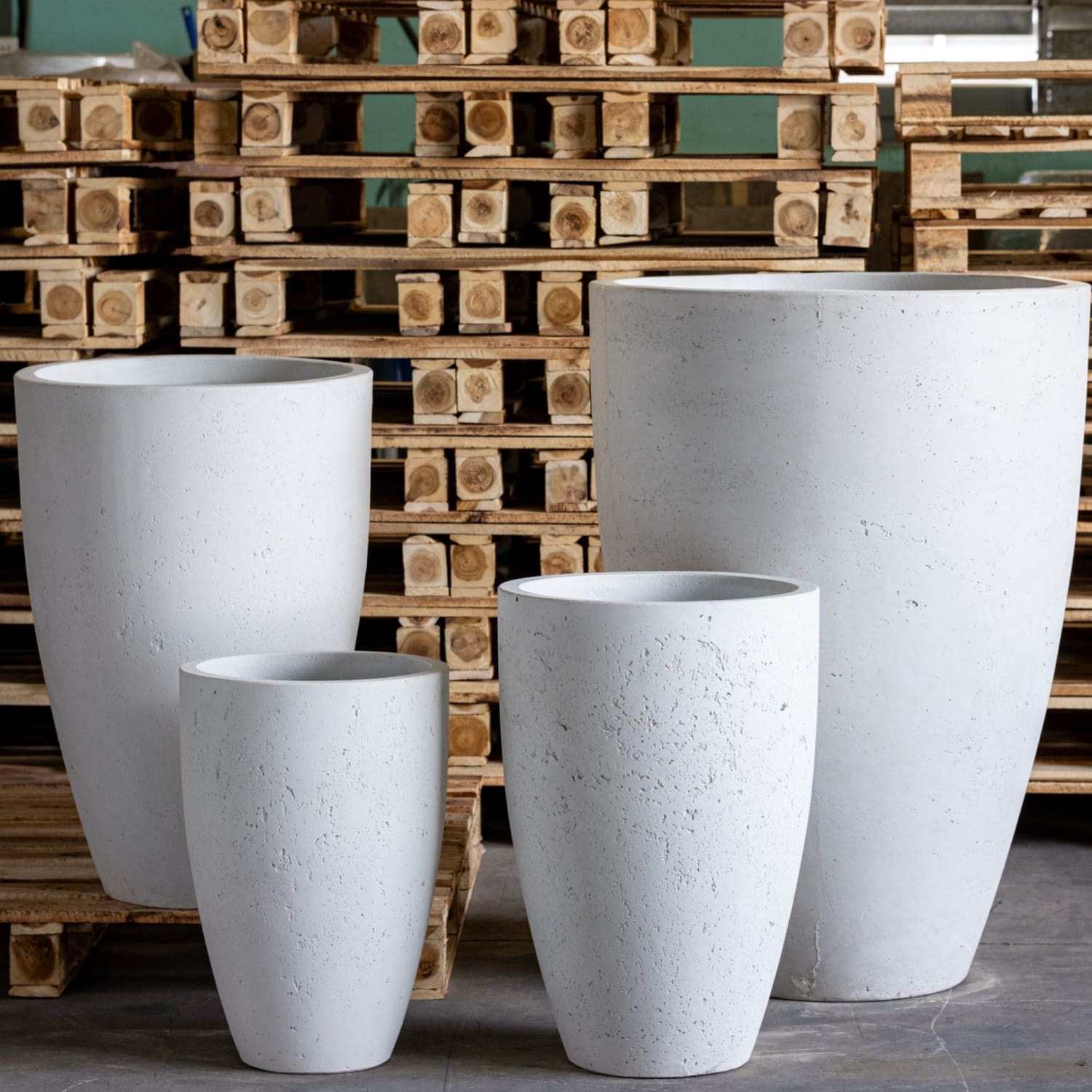 Four white concrete planters.