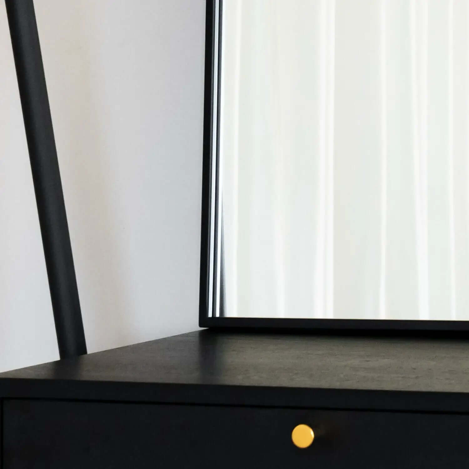 Black desk or table with a yellow knob or handle.