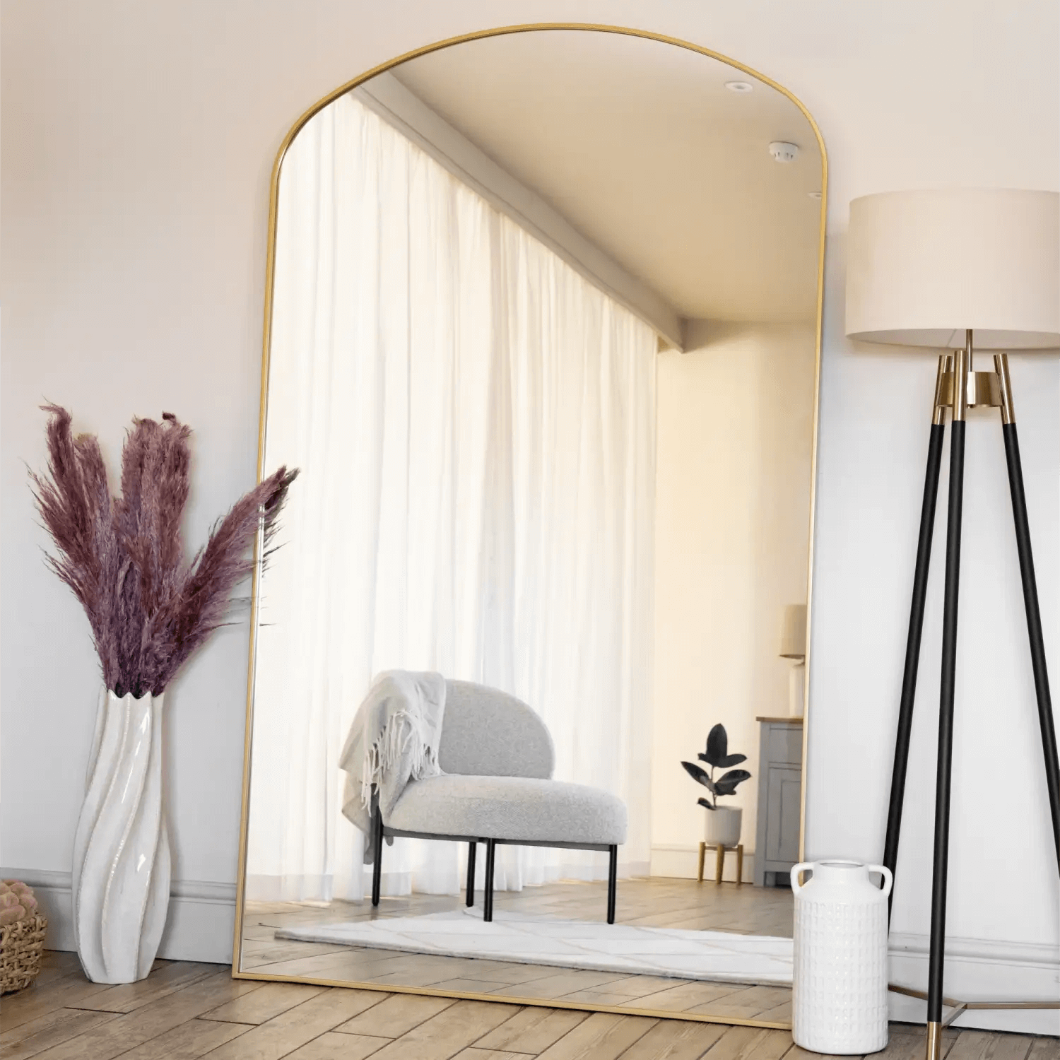 Arched gold-framed mirror with a minimalist design.